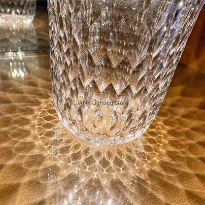 A clear crystal table lamp with intricate diamond pattern and wood lid designed for bedroom night light
