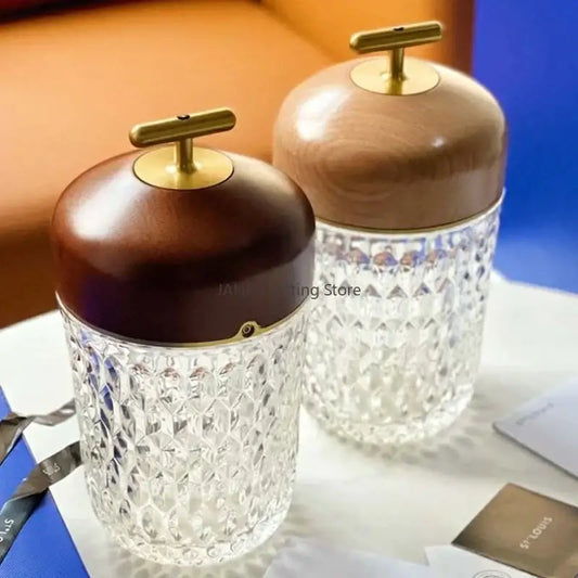 Crystal table lamp with clear faceted glass jars and dark brown wood lids featuring brass t-shaped handles for bedroom use