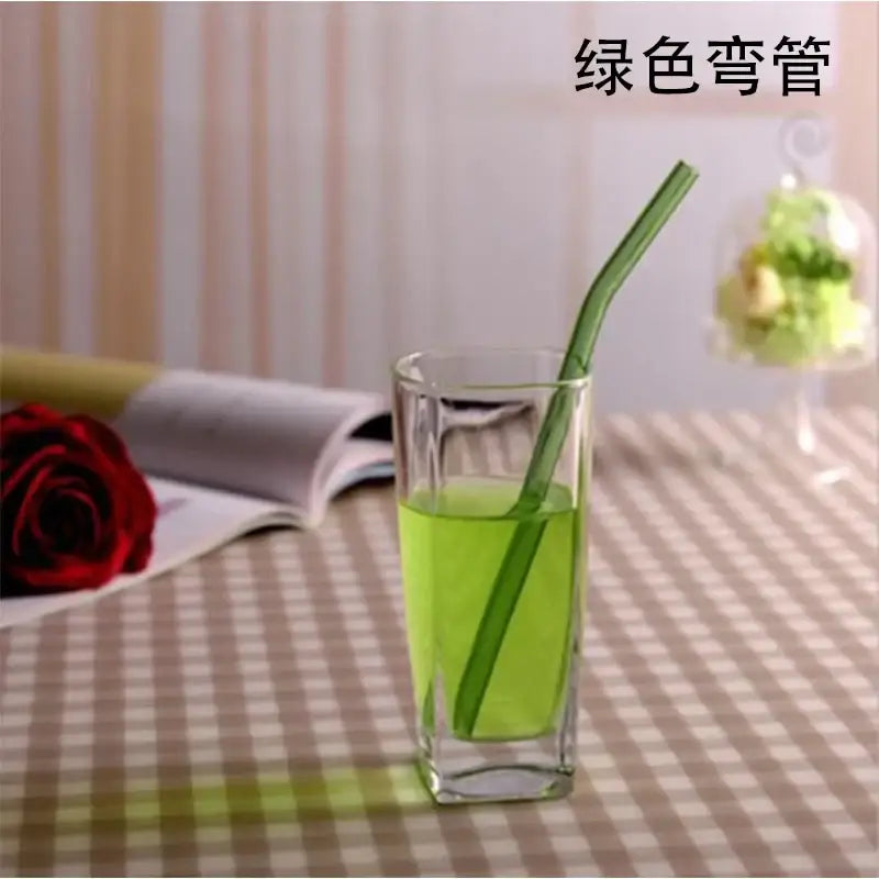 Green curved glass drinking straw made of durable glass for an eco-friendly kitchen accessory