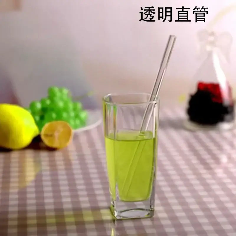 Transparent straight glass drinking straw shown alongside curved amber glass drinking straw kitchen accessory
