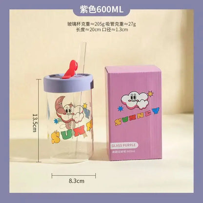 A clear glass cup with purple lid and straw featuring a pink blue and yellow cartoon moon decorbites cartoon glass