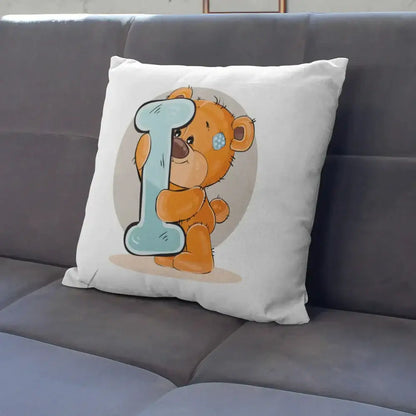 White pillow case with cute cartoon bear animal holding a light blue letter i and wearing a blue polka-dotted eye patch