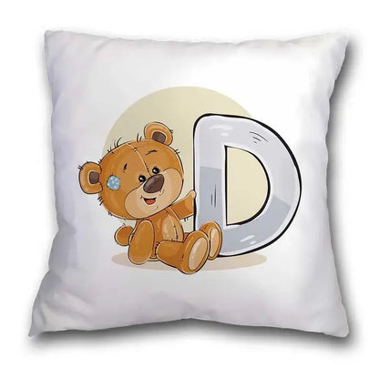 White throw pillow case featuring a cute cartoon bear animal with blue eye patch beside a large silver letter d