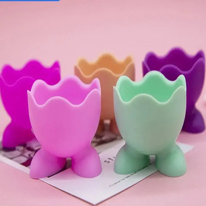 Pastel-colored silicone egg cup holder with scalloped rim and three legs, a colorful and cute egg cup holder