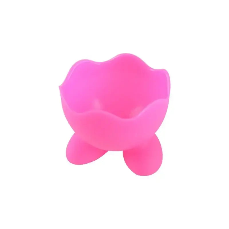 Pink silicone egg cup holder with flower-shaped rim and three rounded feet for kitchen breakfast use