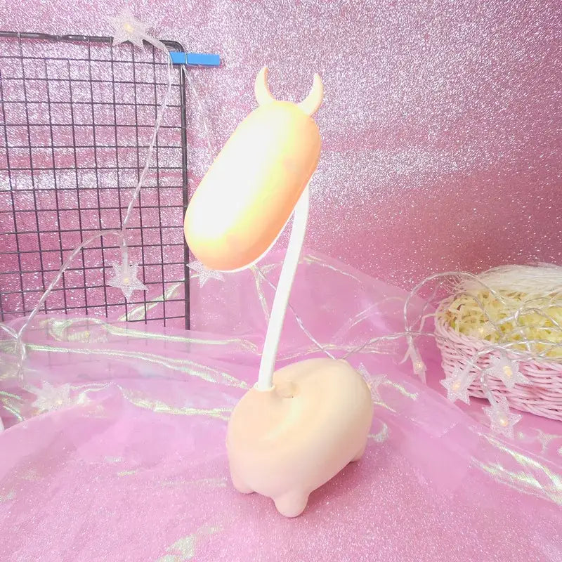 Pastel peach-colored soft plastic cute pig elk night lamp with small horns and flexible neck for desk decorbites elk night