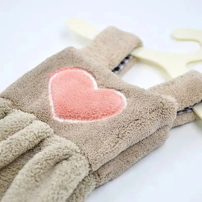 Beige plush fleece overalls with soft pink heart patch in a cute cartoon hand towel for kitchen decor