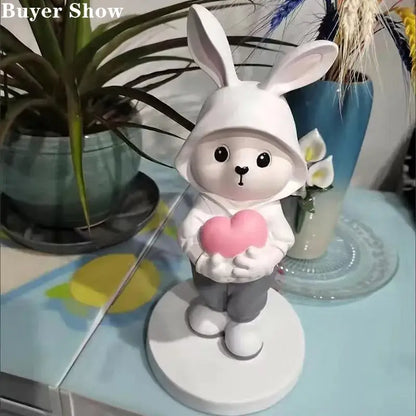White bunny figurine wearing a hooded outfit holding a pink heart for home decor and rabbit desk figurines