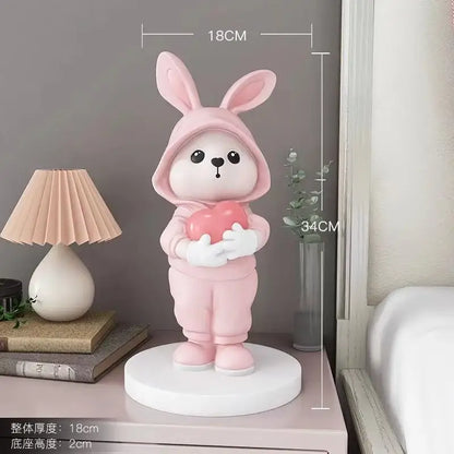 Cute pink rabbit desk figurines crafted from smooth resin with glossy finish holding heart for home decor