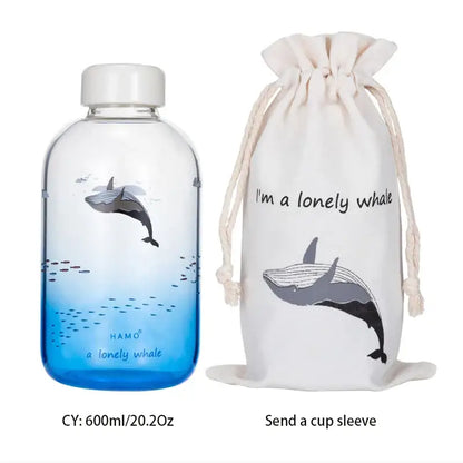 Clear glass water bottle with white cap featuring a lonely whale design by hamo from decorbites blue glass water collection