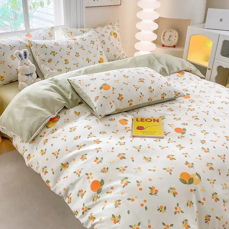 A soft white duvet cover with orange fruits and green leaves in decorbites cute printed cotton cream and navy bedding set