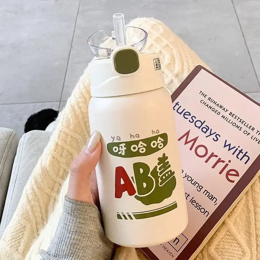 White insulated thermos cup with green and red cartoon design, clear straw, and olive-green cap by decorbites cute straw for travel and kitchen