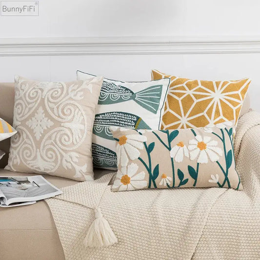 Beige pillow cover with white embroidered floral pattern and green accents featuring soft textured fabric by decorbites daisy home