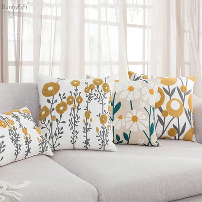 Set of three decorbites daisy home pillow covers with embroidered floral patterns in mustard yellow white and teal on beige