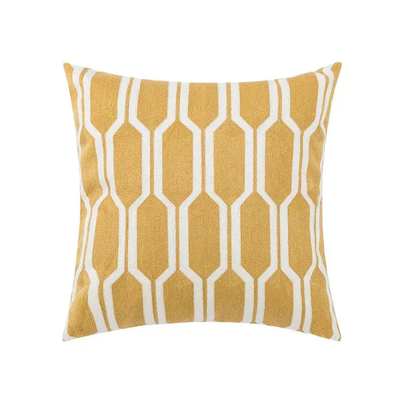 A square throw pillow with mustard yellow base and white geometric embroidery for decorbites daisy floral decor