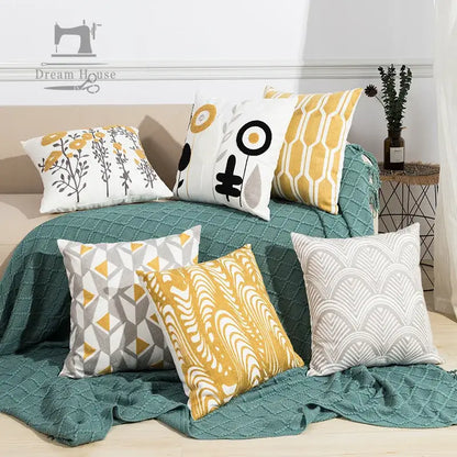 Set of six decorative throw pillows in yellow white gray and teal featuring daisy floral geometric embroidery for living room decor