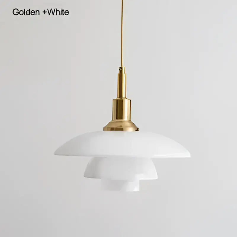 White layered glass pendant light with a golden brass fixture creating a focal point for dining room lighting