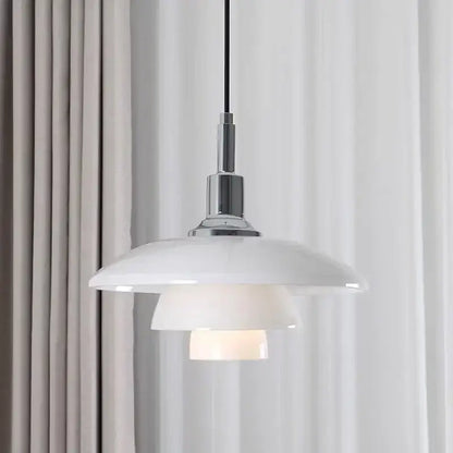 White ceramic glass pendant light with sleek layered design and chrome hardware as a dining room focal point