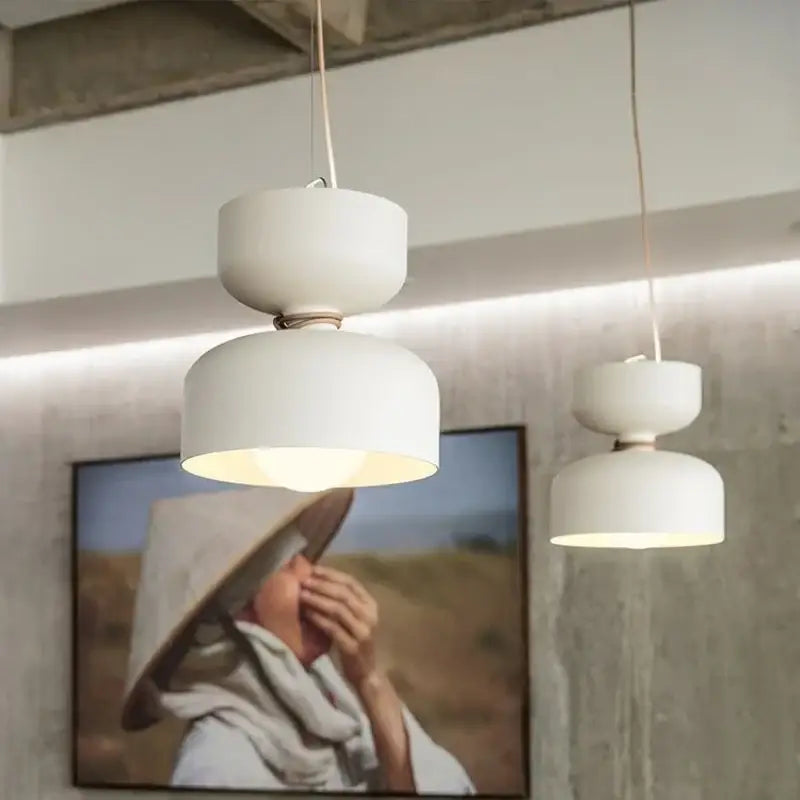 White ceramic Danish pendant light with modern stacked-disk design wrought iron frame and LED bulb for kitchens