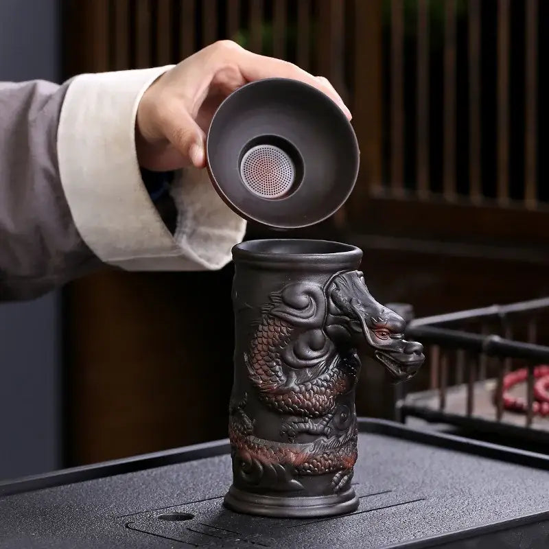 Dark brown ceramic dragon tea cup with intricate design and matching lid featuring funnel filter for decorbites dragon tea use