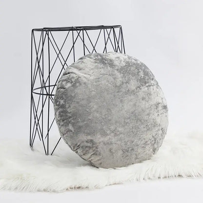A dark grain velvet pillow cover in gray with a plush textured surface on a white faux fur rug for decorbites decor