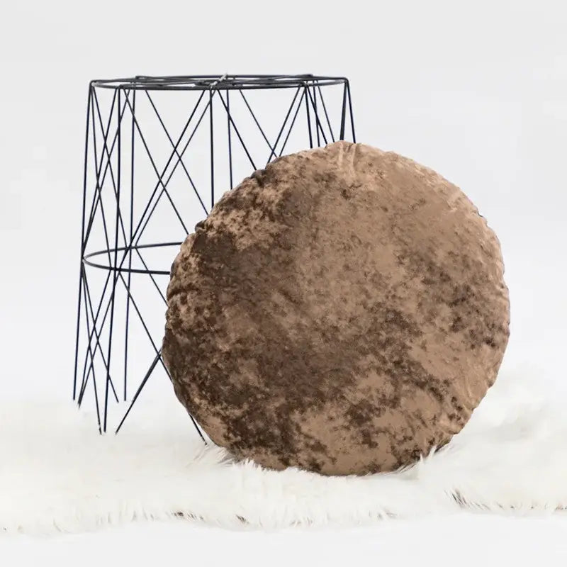A round plush brown velvet pillow cover with a textured dark grain surface ideal for decorbites dark grain decorbites dark grain