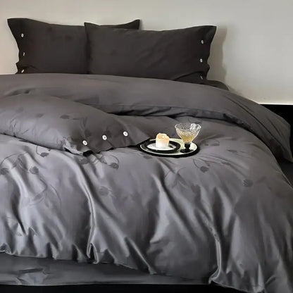 Dark gray egyptian cotton bedding set with subtle floral embroidery and button detailing on pillowcases in a bedroom