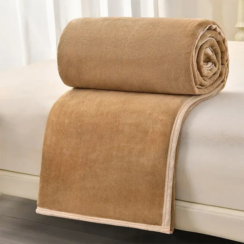 A plush tan fleece blanket with cream binding paired with dark gray and light gray decorbites cozy flannel blanket for sofa decor