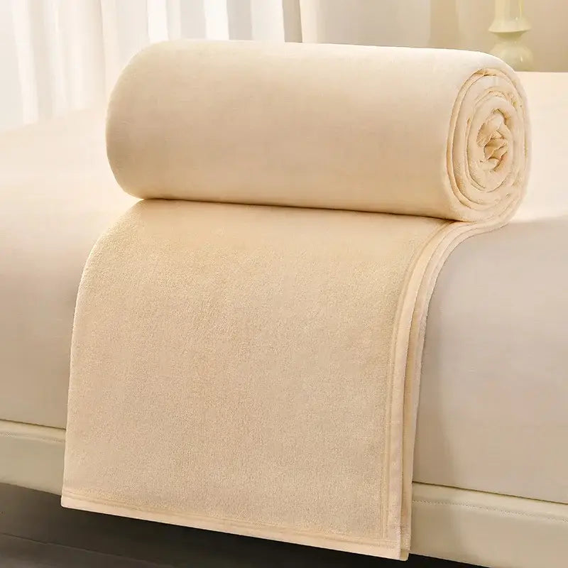 A soft cream-colored fleece blanket with plush texture and finished edges for decorbites cozy flannel living room use