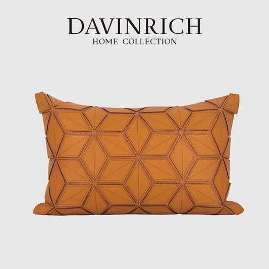 A tan leather pillow cover with dark orange geometric three-dimensional hexagonal stitching for decorbites decor