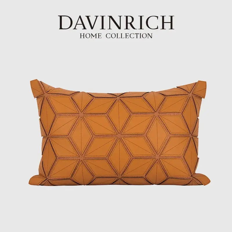 A tan leather pillow cover with dark orange geometric three-dimensional hexagonal stitching for decorbites decor