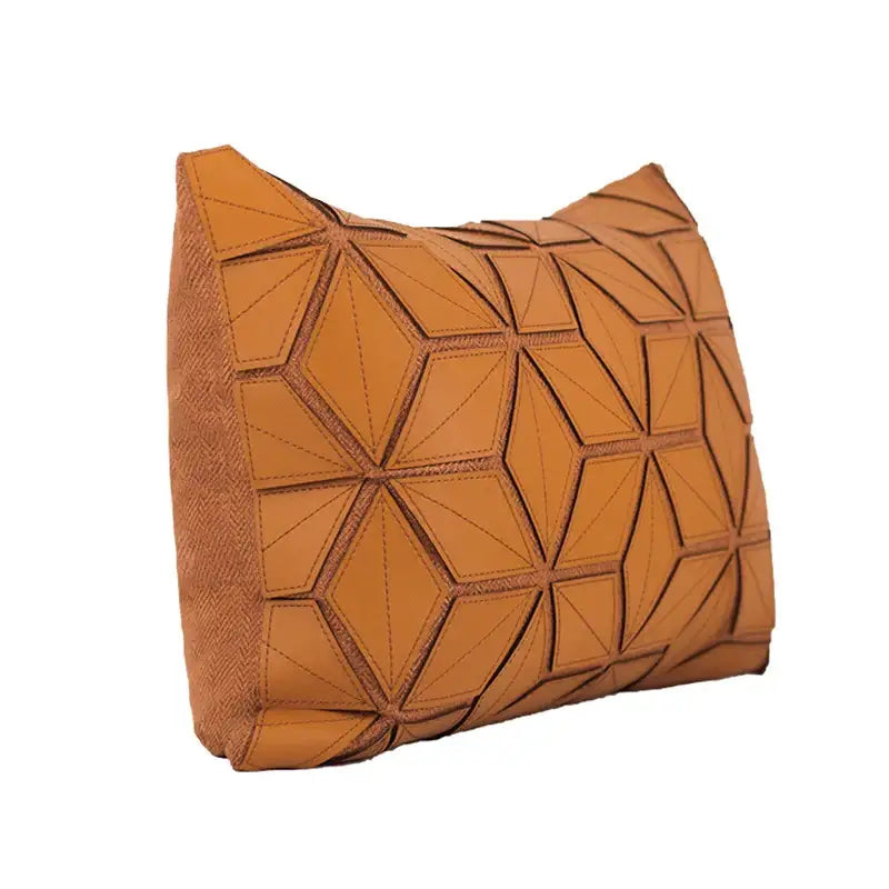 Tan leather clutch with geometric faceted design complementing decorbites dark orange geometric pillow cover decor