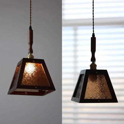 Dark wood and glass led pendant lamp with textured amber panels and twisted cord suspension for dining room use