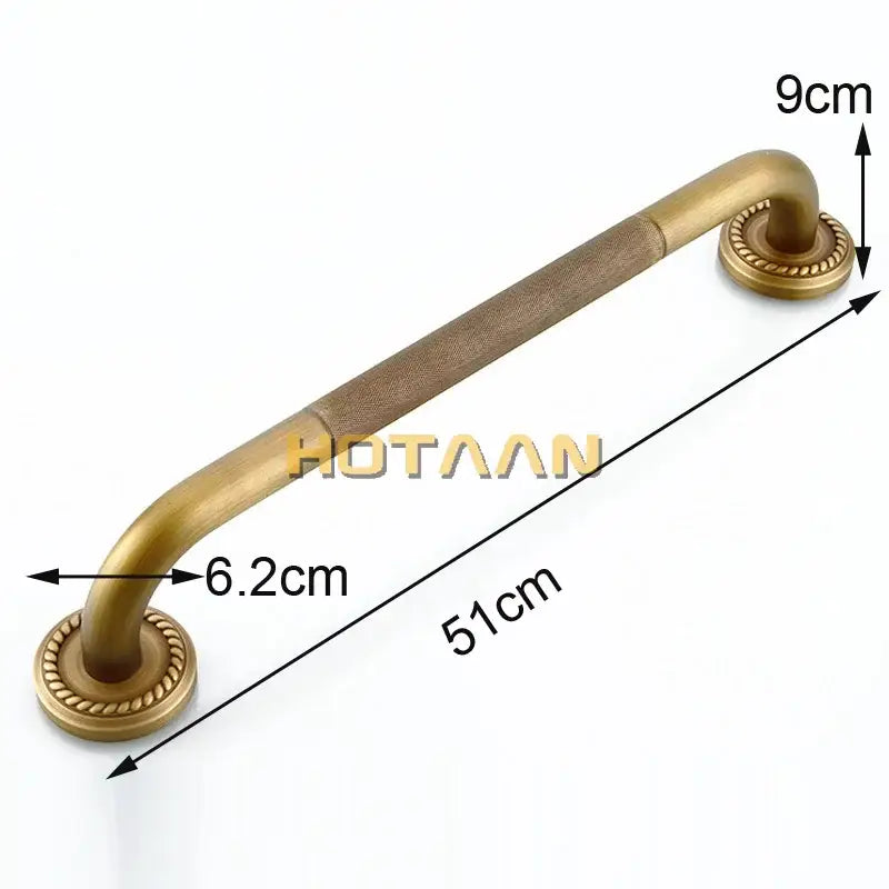 Antique brass bathroom safety grab bar with textured grip and ornate circular end caps for toilet use