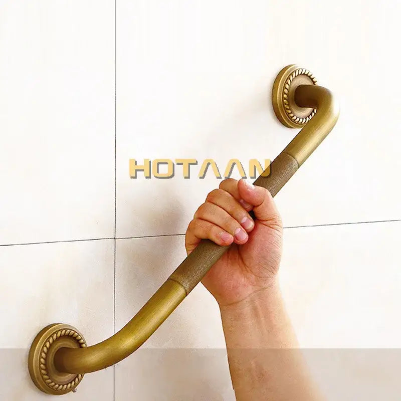 Decorative brass bathroom safety grab bar with rope detail and curved design for enhanced bathroom safety grab use