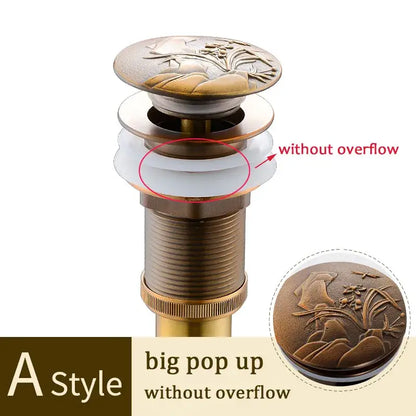 Antique brass-colored decorative tree motif pop-up drain stopper with ornate floral and landscape design for bathroom sink decorbites brass bathroom