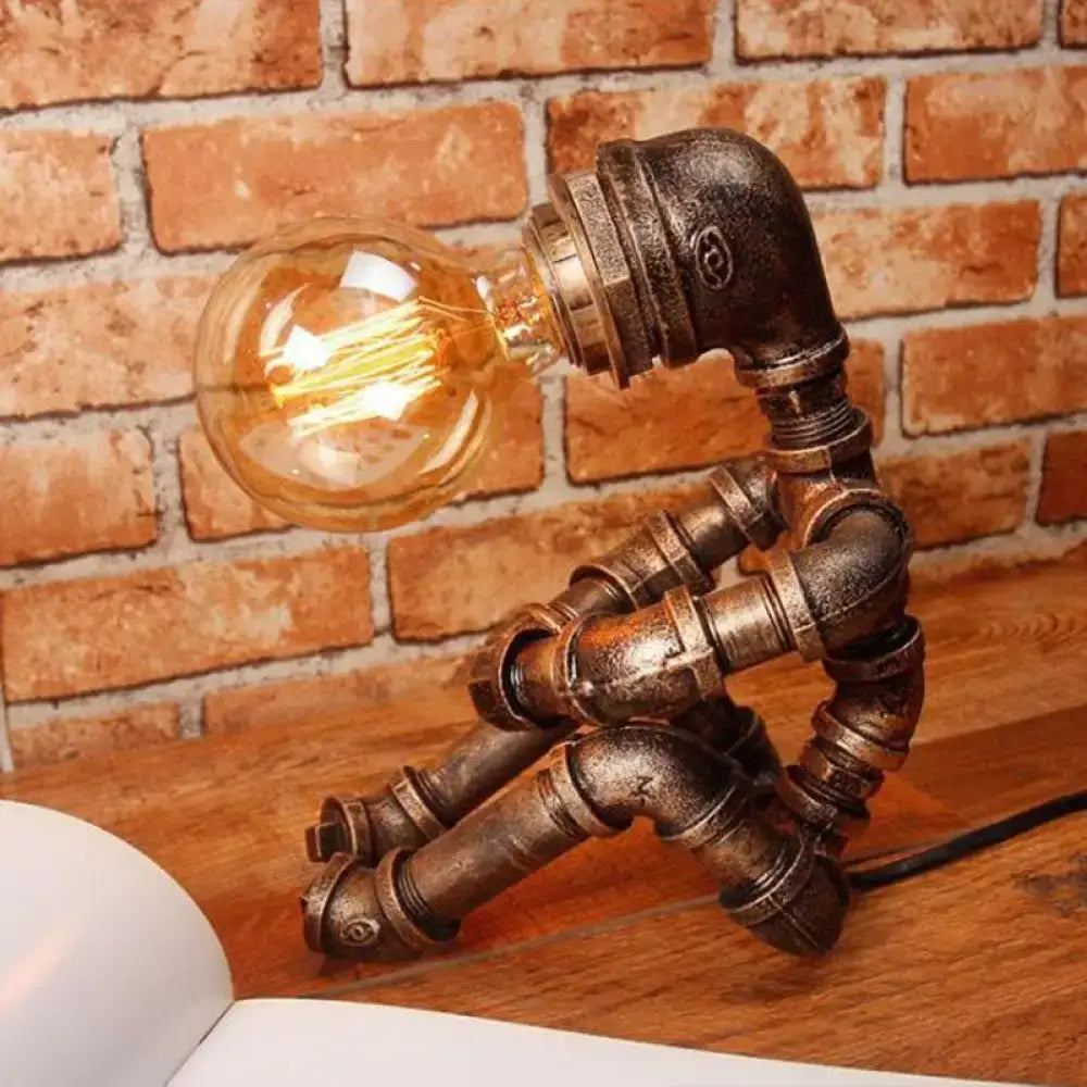 DecorBites 1-light industrial robot table lamp with antiqued bronze metal articulated body and exposed filament bulb