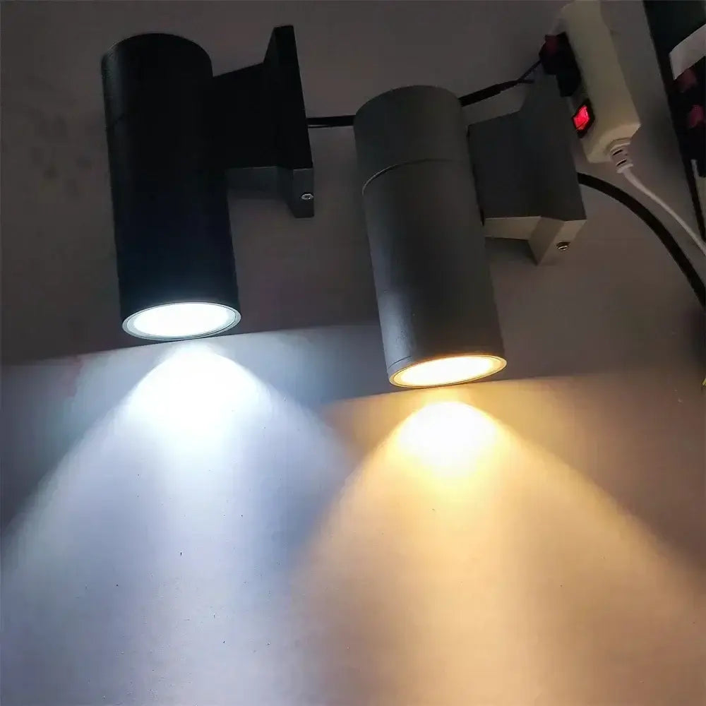 Modern black cylindrical 10w light wall outdoor porch spotlight with adjustable heads emitting white and warm yellow light