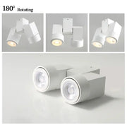 Modern white downlight surface mount with sleek geometric design and 180 degree rotating heads for living room use