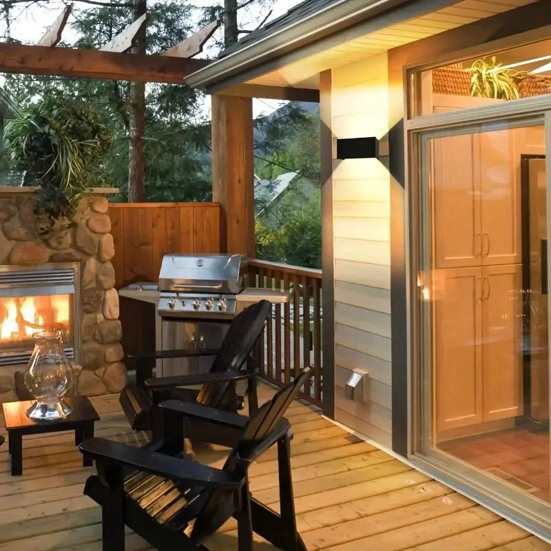 Modern black minimalist 24w led wall light outdoor sconce shown above black wooden adirondack chairs on a deck