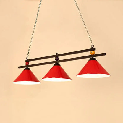 Red conical pendant lighting fixture with black metal frame chain suspension and pool ball accents for indoor use