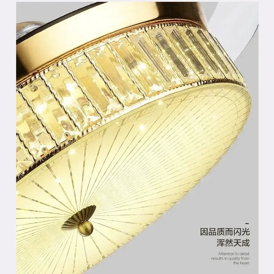 Modern gold crystal ceiling fan with retractable blades and sunburst shade featuring rectangular crystal accents