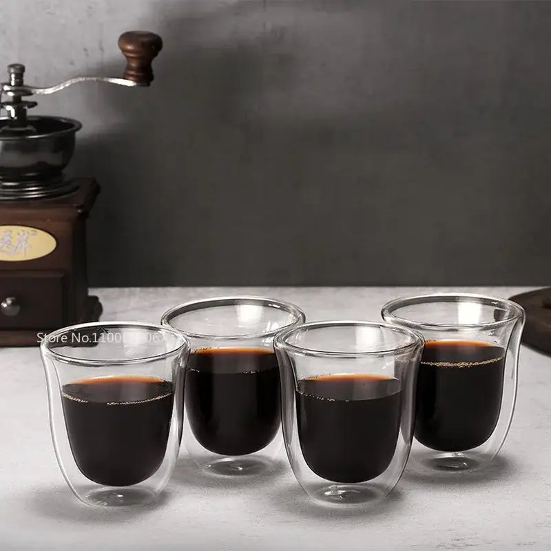 Set of four clear double wall glass coffee mugs filled with dark liquid from decorbites 5pcs insulated cups set