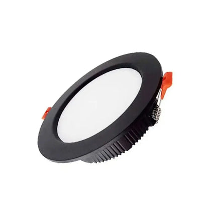 Black circular DecorBites™ 5W led downlight with textured rim and orange clips for bright recessed ceiling in home living room