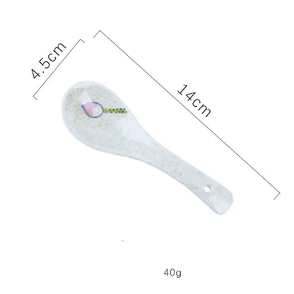 A white ceramic spoon with pink and green design and hanging hole from decorbites retro ceramic ramen bowl set