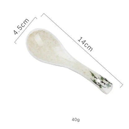 A delicate off-white ceramic spoon rest with green floral design included in decorbites™ retro ceramic ramen bowl set