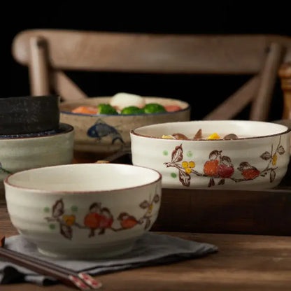 White ceramic ramen bowl with hand-painted fruit and bird motifs and rustic brown rim for kitchen and hotel use