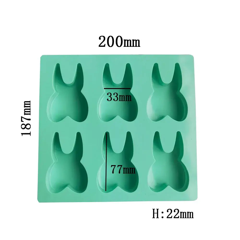 A mint green silicone mold with six bunny-shaped cavities from decorbites™ 6 hole tooth silicone mold bakeware