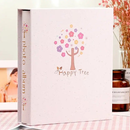 A soft pink DecorBites™ 6-inch scrapbook album with happy tree design for family baby wedding memories