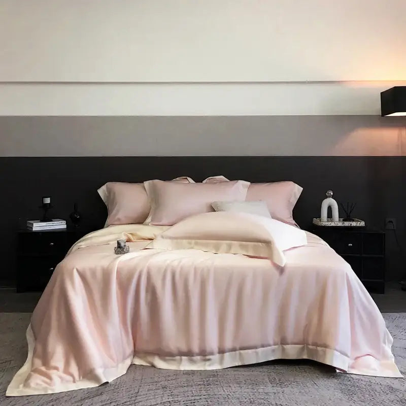 A soft blush pink satin duvet cover bedding set made from lyocell eucalyptus fiber elegantly draped over a bed